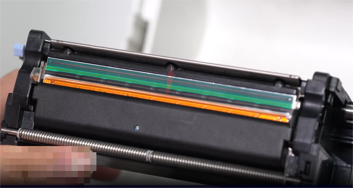 ए close-up of a person carefully cleaning an electronic component with a swab.